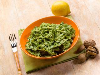 pasta with spinach pesto almond nuts and lemon peel