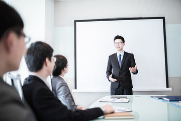 businessman giving a presentation to his colleagues