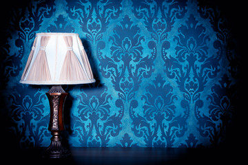 Vintage lamp on blue rococo pattern background