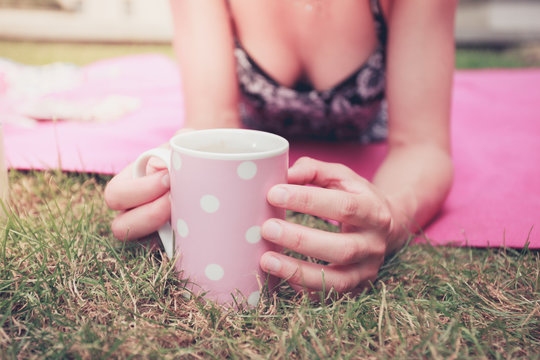Young woman having tea outside
