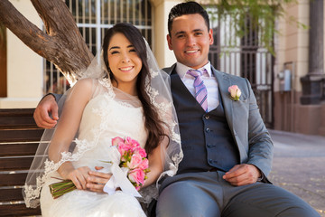 Newlyweds sitting on a bench