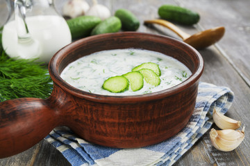 Summer soup with cucumbers, yogurt and fresh herbs