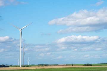 Fototapeta na wymiar Wind generator turbine on summer landscape