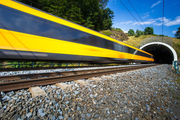 Fast train passing through a tunnel on a lovely summer day