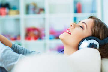 Relax with listening music. Young woman