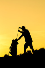 Golfer at sunset