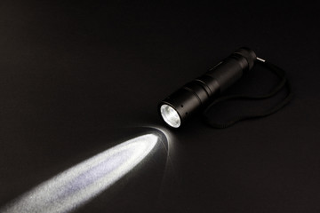 flashlight with a light beam - obrazy, fototapety, plakaty