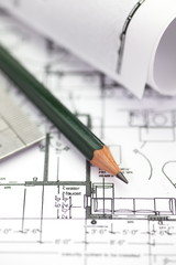 Architect rolls and plans construction project drawing