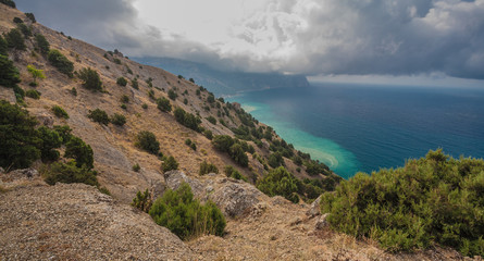 Beach between rocks and sea.