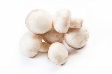 Group of champignon mushrooms isolated on white.