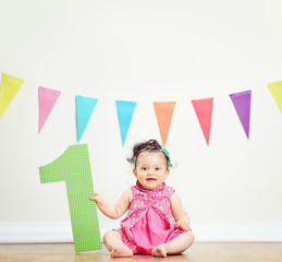 Fototapeta na wymiar Cute baby girl celebrating her first birthday