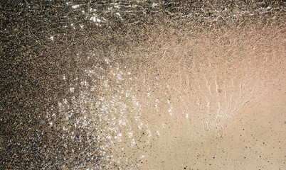 Wet sand washed by sea tide background