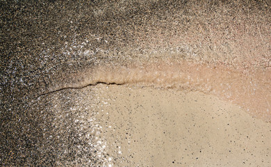 Wet sand washed by sea tide background