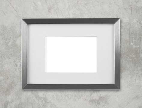 Blank silver picture frame on the wall