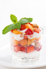 dessert with strawberries, apricots, whipped cream and granola