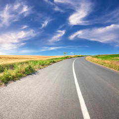 Driving on an empty asphalt road at sunny day