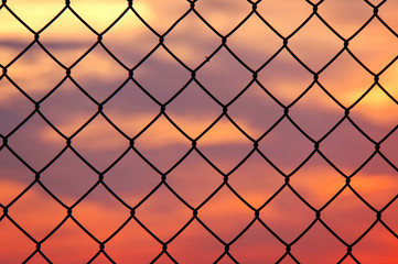 Fototapeta premium metallic fence at sunset