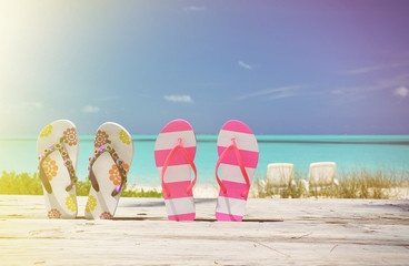 Two pairs of flip-flops against Atlantic. Exuma, Bahamas