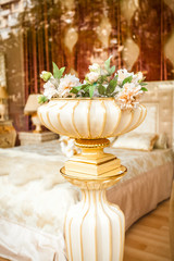 antique porcelain vase with flowers at classic interior