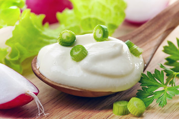 cream in a wooden spoon