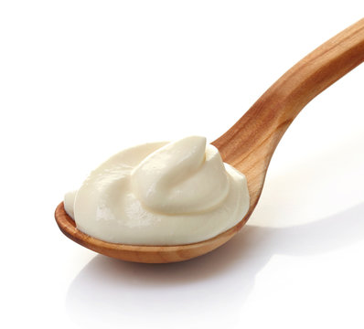 cream in a wooden spoon