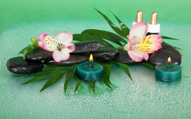 Candles and aroma oil, stones, flower