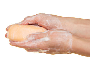 Piece of toilet soap in the female hands
