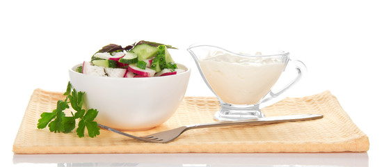 Bowl with salad, sour cream and fork