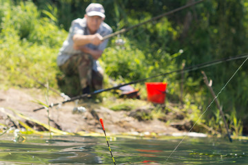 Man fishing at the edge of a lake