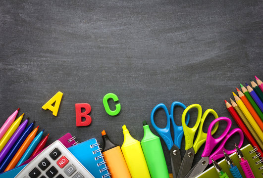 School supplies on blackboard background