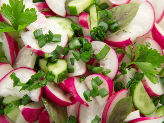 Salad from radish and cucumbers with greens