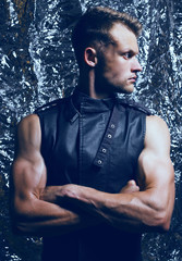 Fototapeta premium Arty portrait of muscular young and handsome man with muscular h