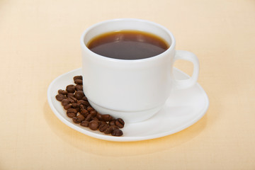 White cup of coffee with grains