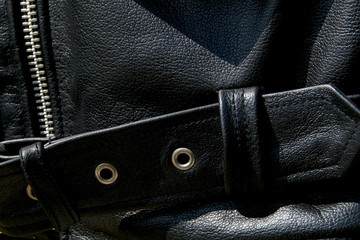 close up of black leather biker jacket belt