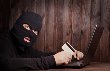 Hacker holding a credit card