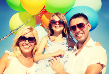 happy family with colorful balloons outdoors