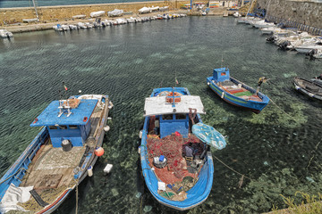 Fisherman repairs his net on boat