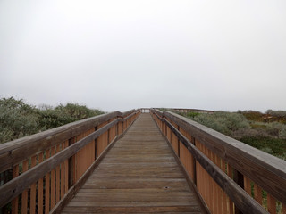 Long Wooden Path with wood railings on a foggy day