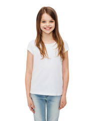 Obraz premium smiling little girl in white blank t-shirt