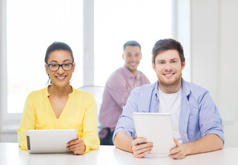 smiling team with tablet pc computers at office