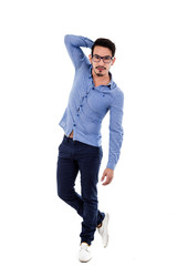 Fototapeta premium young hispanic man with blue shirt touching his hair posing