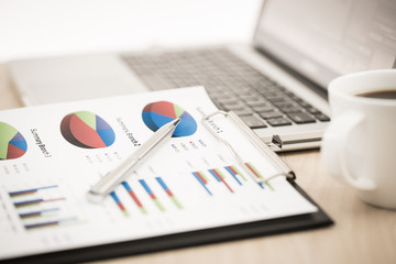 Fototapeta premium Businessman analyzing investment charts with laptop