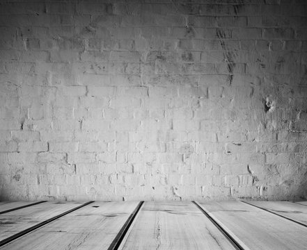 Empty wood floor and white brick wall background