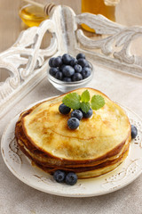 Stack of pancakes with syrup and blueberries