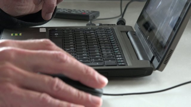 Hacker typing program on a laptop keyboard