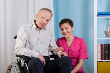 Disabled man and nurse in a hospice