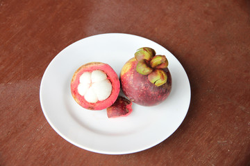 Fresh mangosteen fruit of peeling in dish.