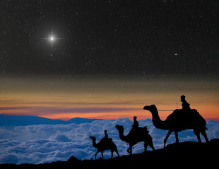 The 3 wise men follow Christmas star over the mountains.