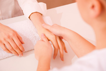 Masseuse massaging hand