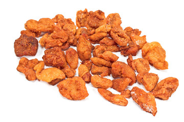 Heap of fried pork greaves isolated on white